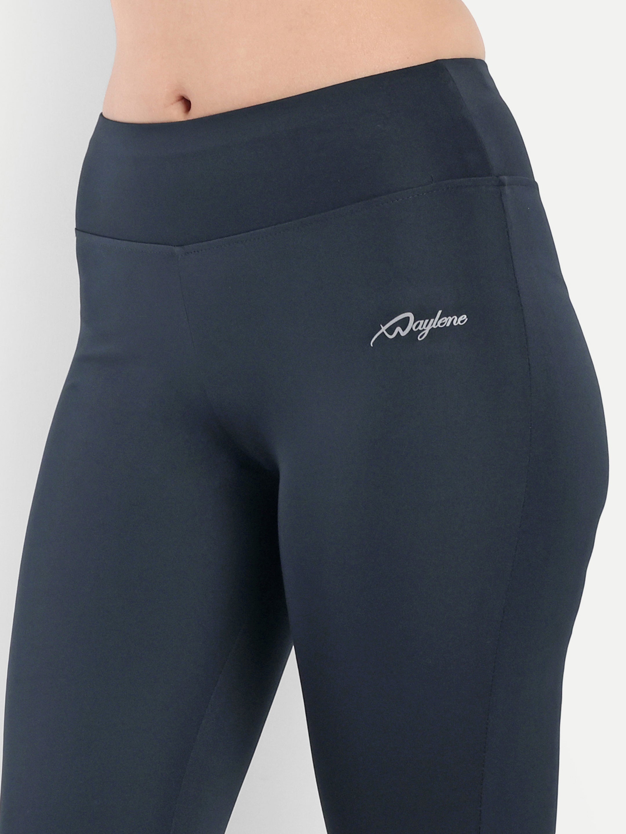 Close-up of Waylene Women's Navy Blue High-Waisted Sports Capris, showing logo detail and smooth waistband.