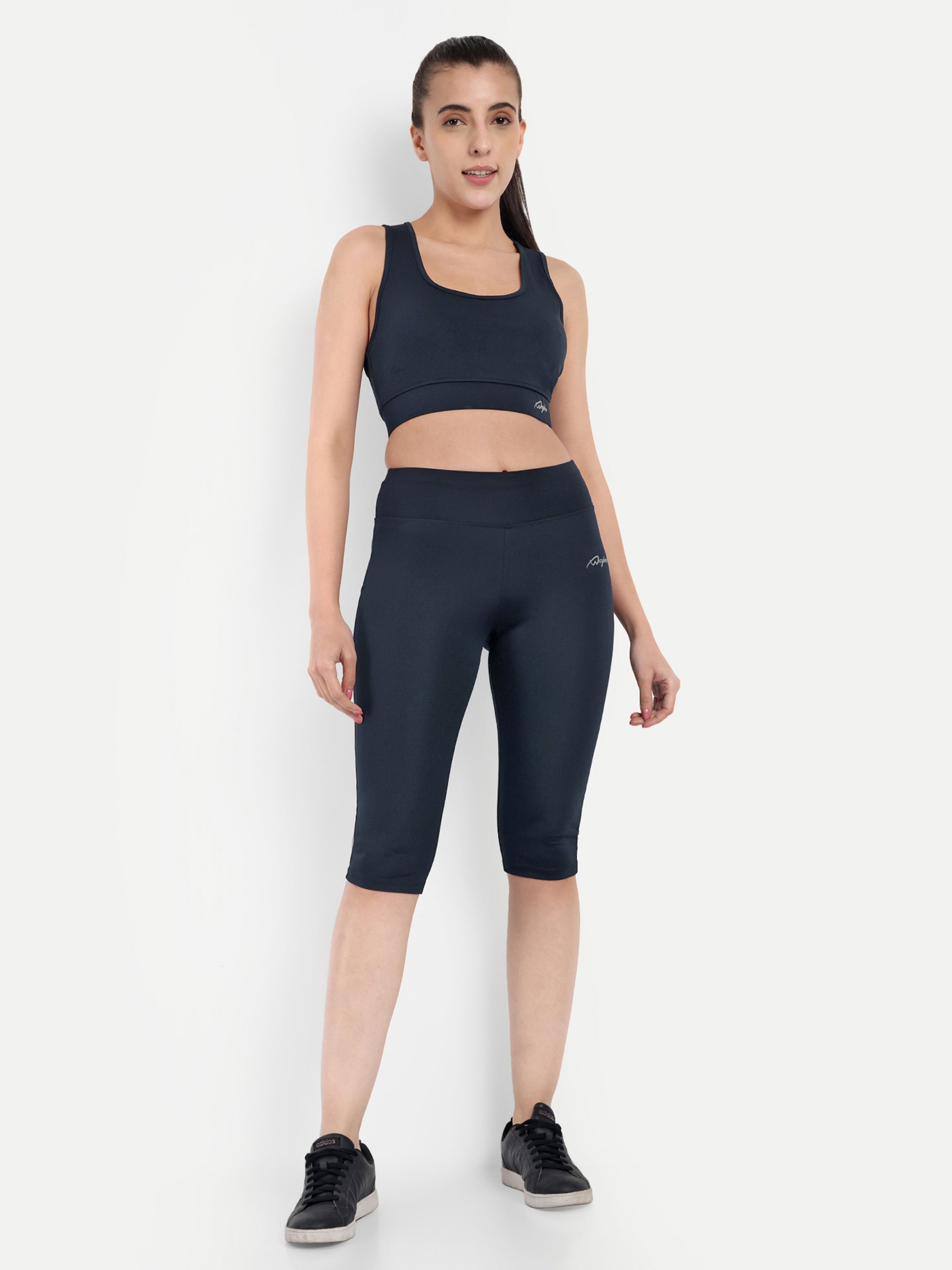 Woman wearing Waylene navy blue high-waisted plain sports capris with sports bra