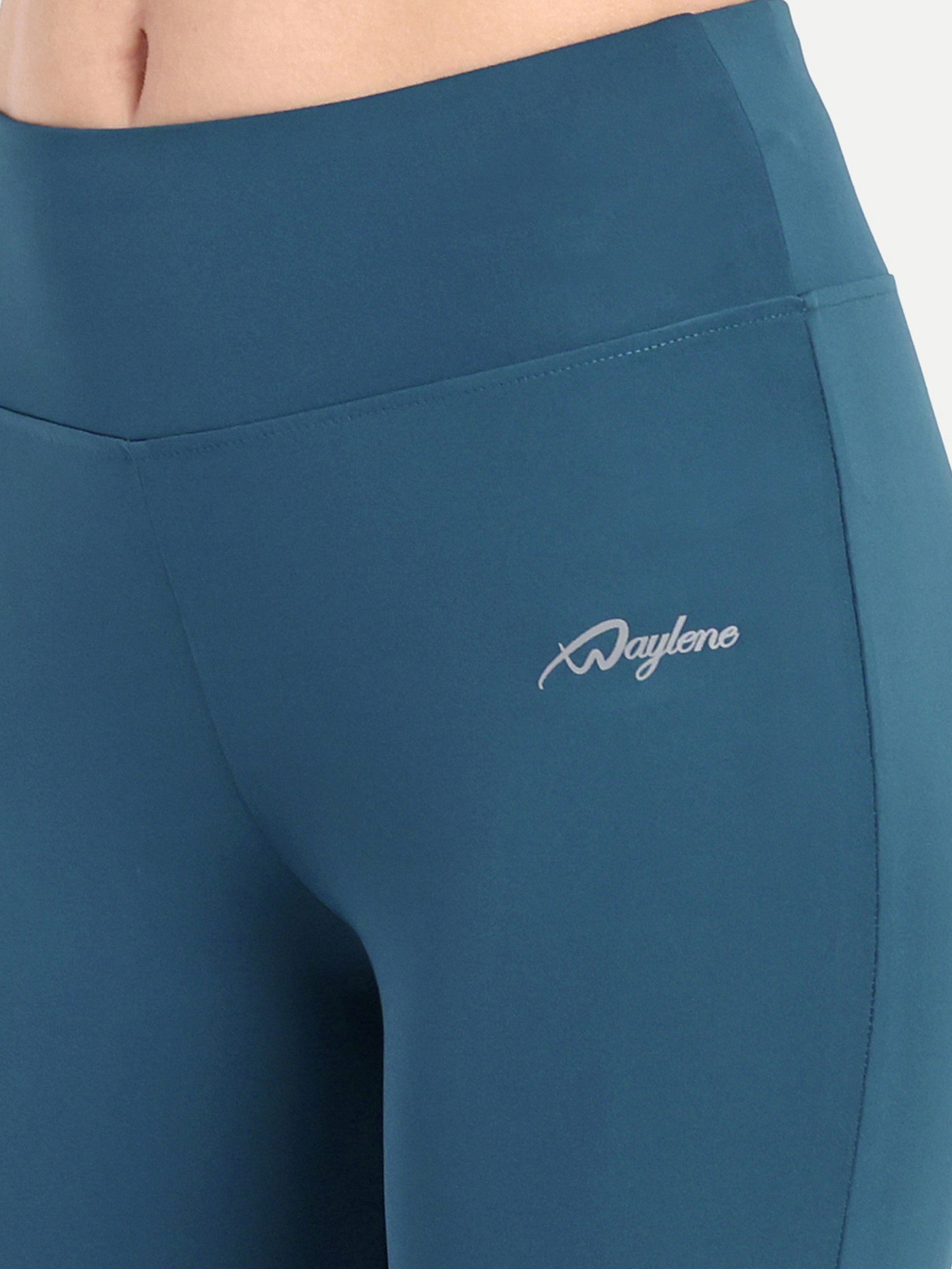 Detailed view of Waylene's teal blue capri, focusing on the hip area with the Waylene logo, showcasing the brand's signature style and quality.