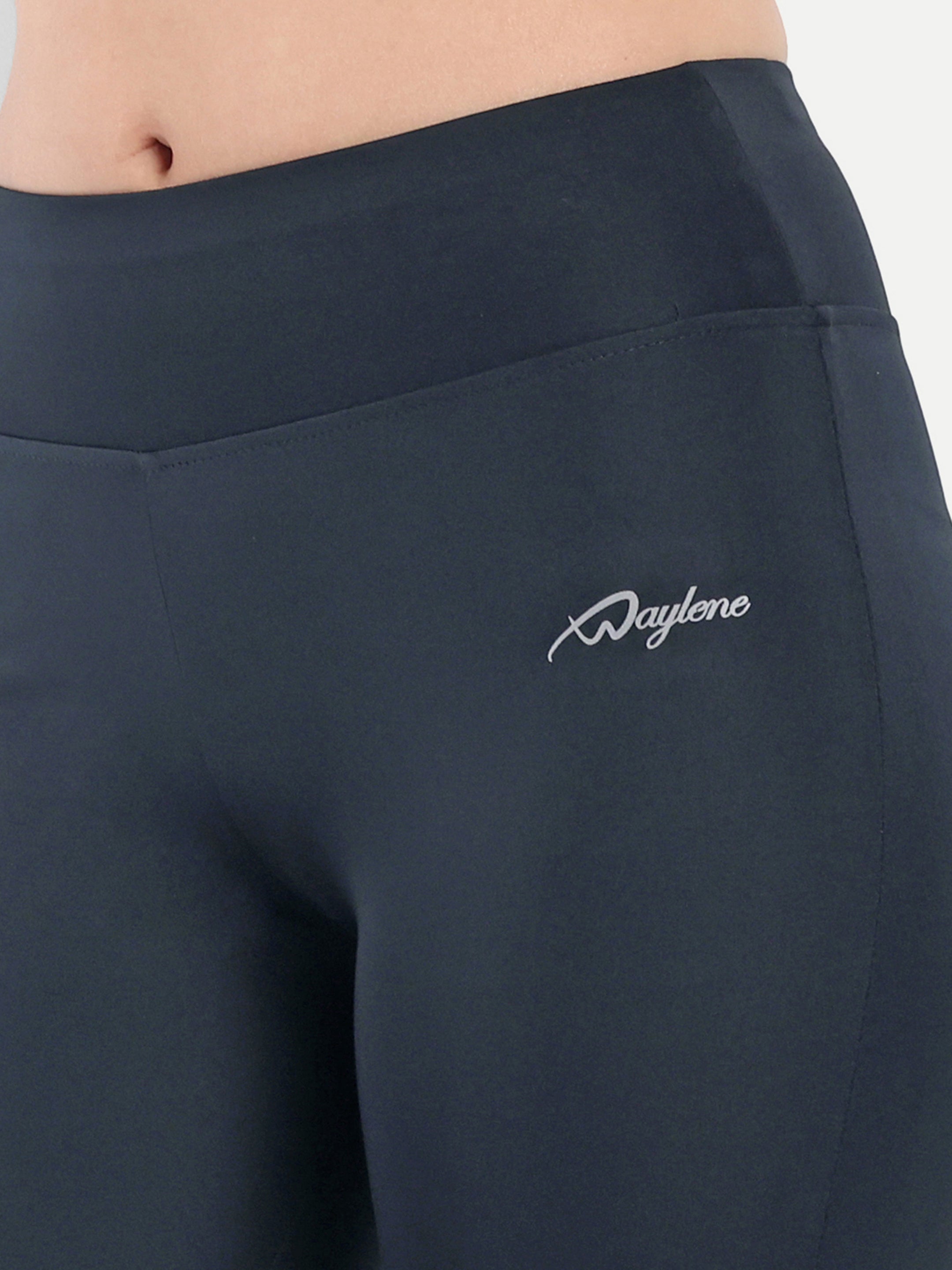ALT text: Close-up of the back waistband of Waylene's navy blue capri tights, focusing on the elegant logo detailing.