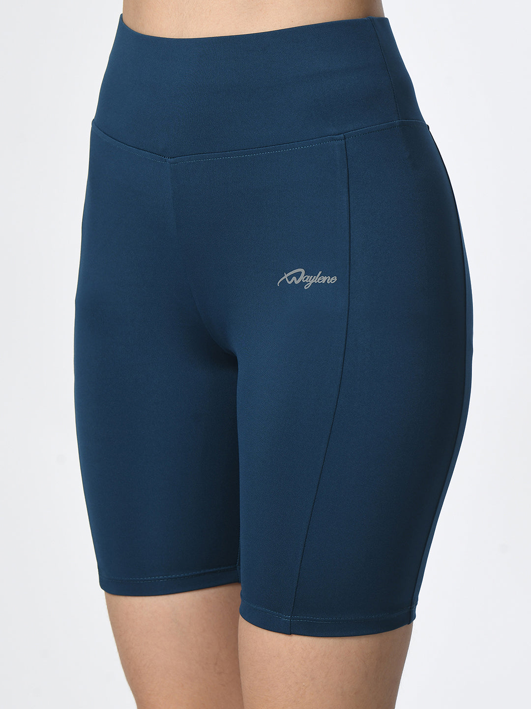 Close-up of Waylene Teal Blue Shorts showing logo and smooth fabric texture.