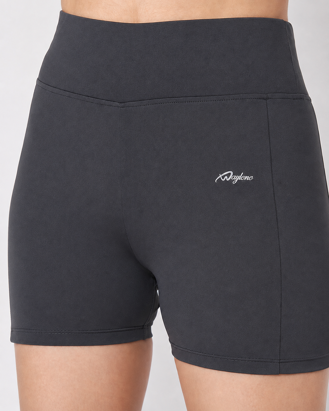 Close-up detail of white Waylene logo on dark grey high waist activewear shorts