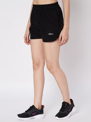 Female model showcasing Waylene's black polyester shorts with a casual pose, hands on hips, paired with black sneakers, highlighting the lightweight and versatile design.