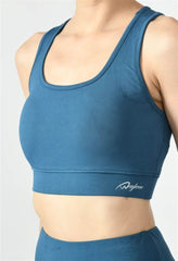 Close-up of Waylene light blue (teal) sports bra showing racerback design and stretchable straps - front view