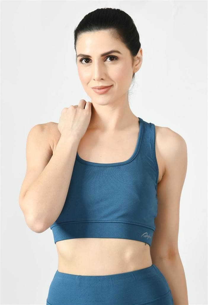 Model showcasing the comfortable fit of Waylene's light blue (teal) sports bra