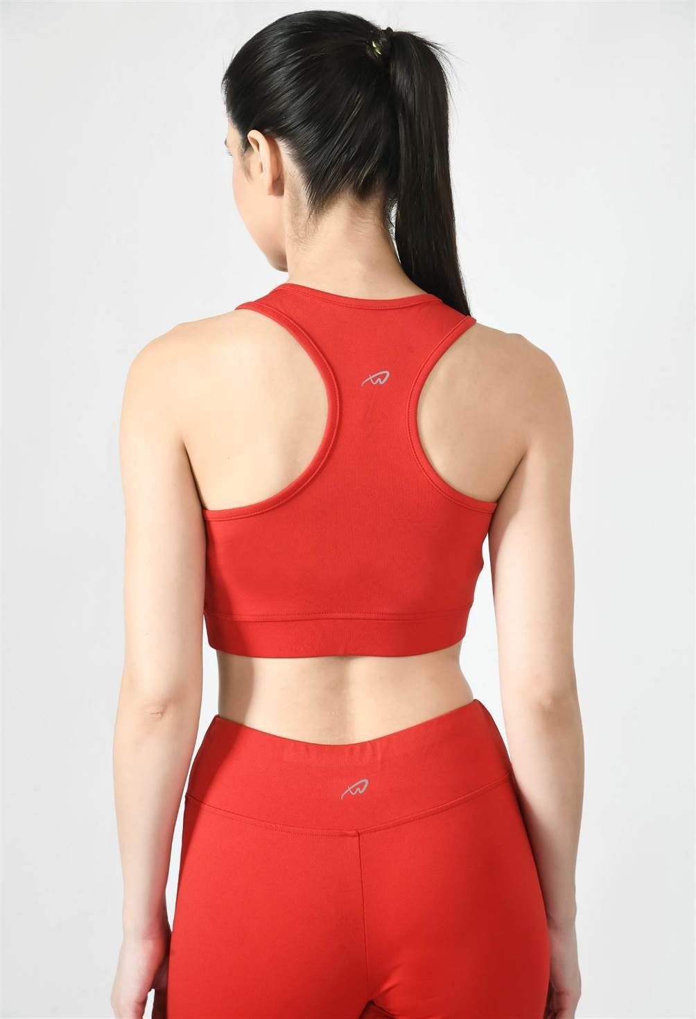 Close-up of Waylene red sports bra showing racerback design and stretchable straps - back view