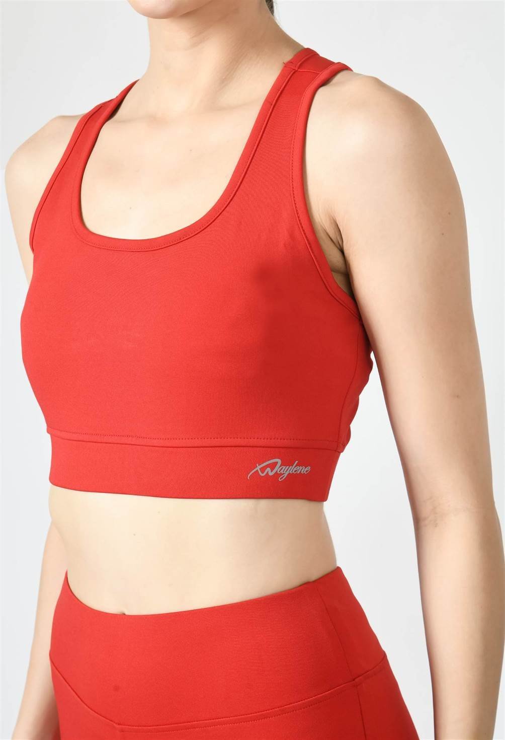 Close-up of Waylene red sports bra showing racerback design and stretchable straps front view