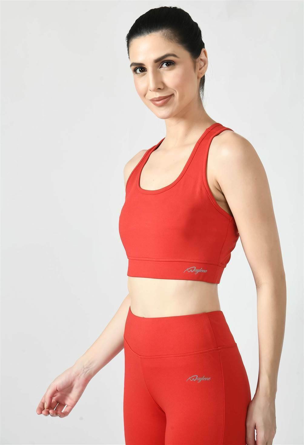 Model showcasing the comfortable fit of Waylene's red sports bra - side view