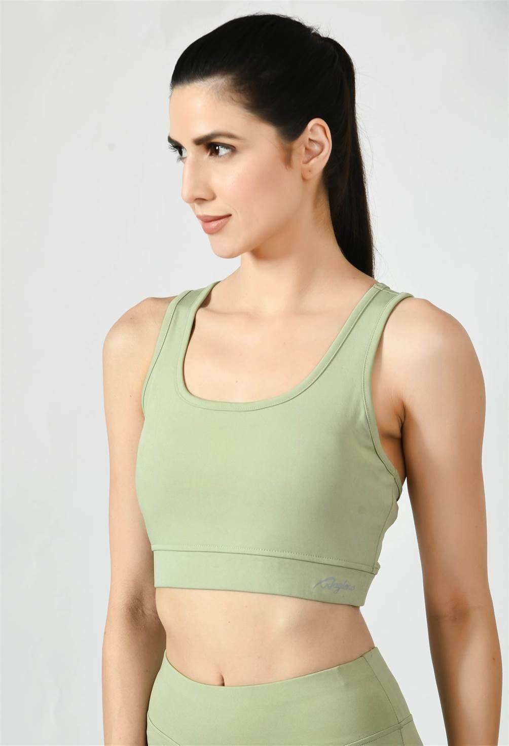 Close-up of Waylene light green (pista green) sports bra showing racerback design and stretchable straps - side view