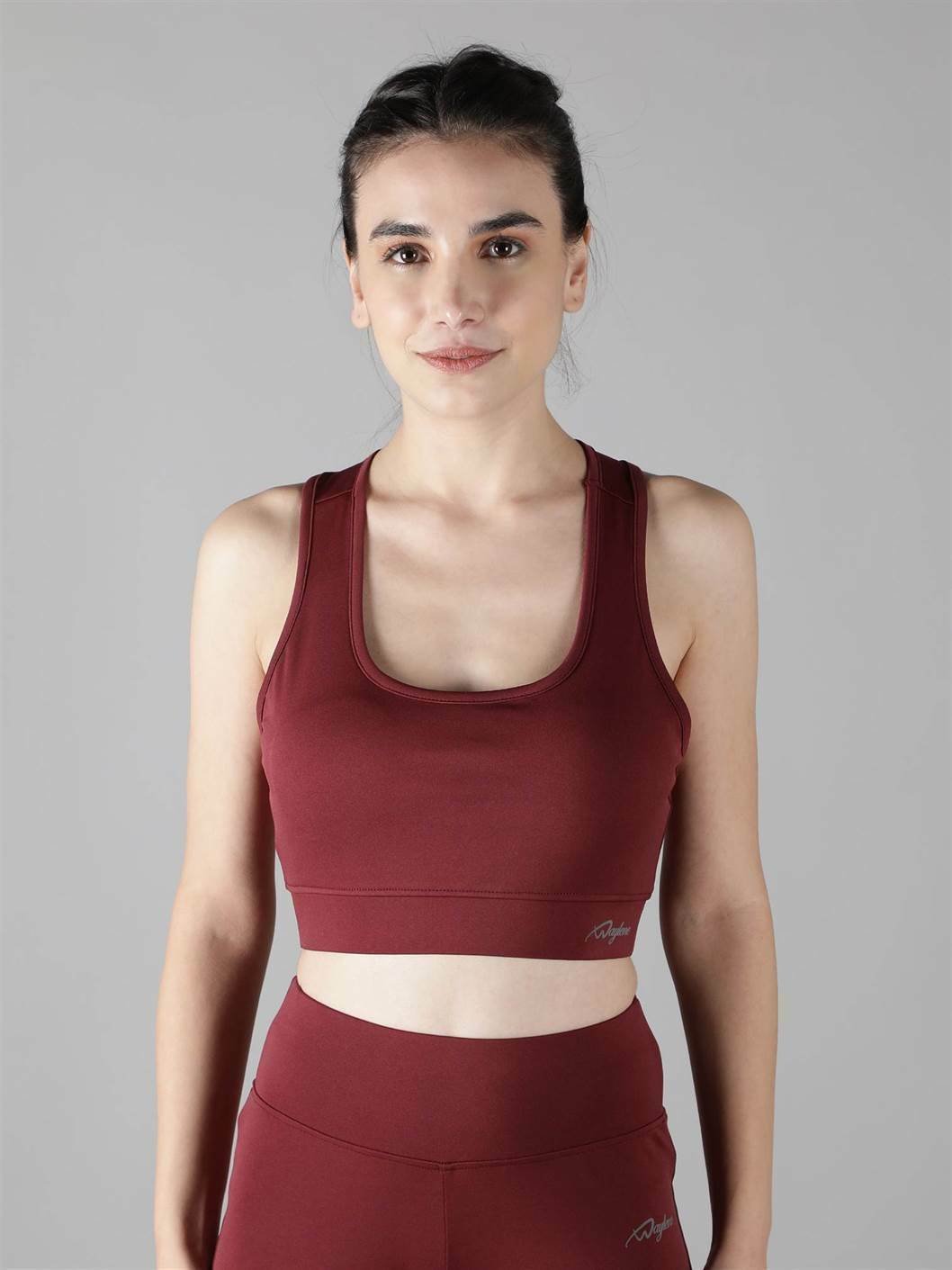 Model showcasing the comfortable fit of Waylene's maroon (wine) sports bra front view