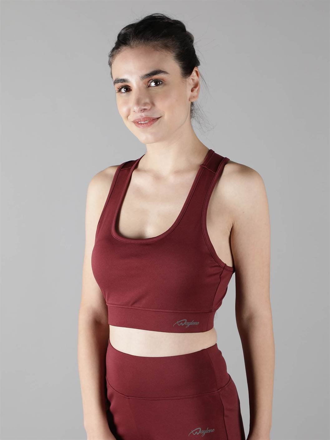 Model showcasing the comfortable fit of Waylene's maroon (wine) sports bra side view