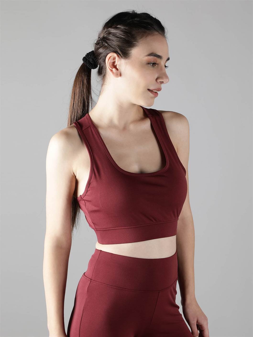 Close-up of Waylene maroon (wine) sports bra showing racerback design and lightly padded cups