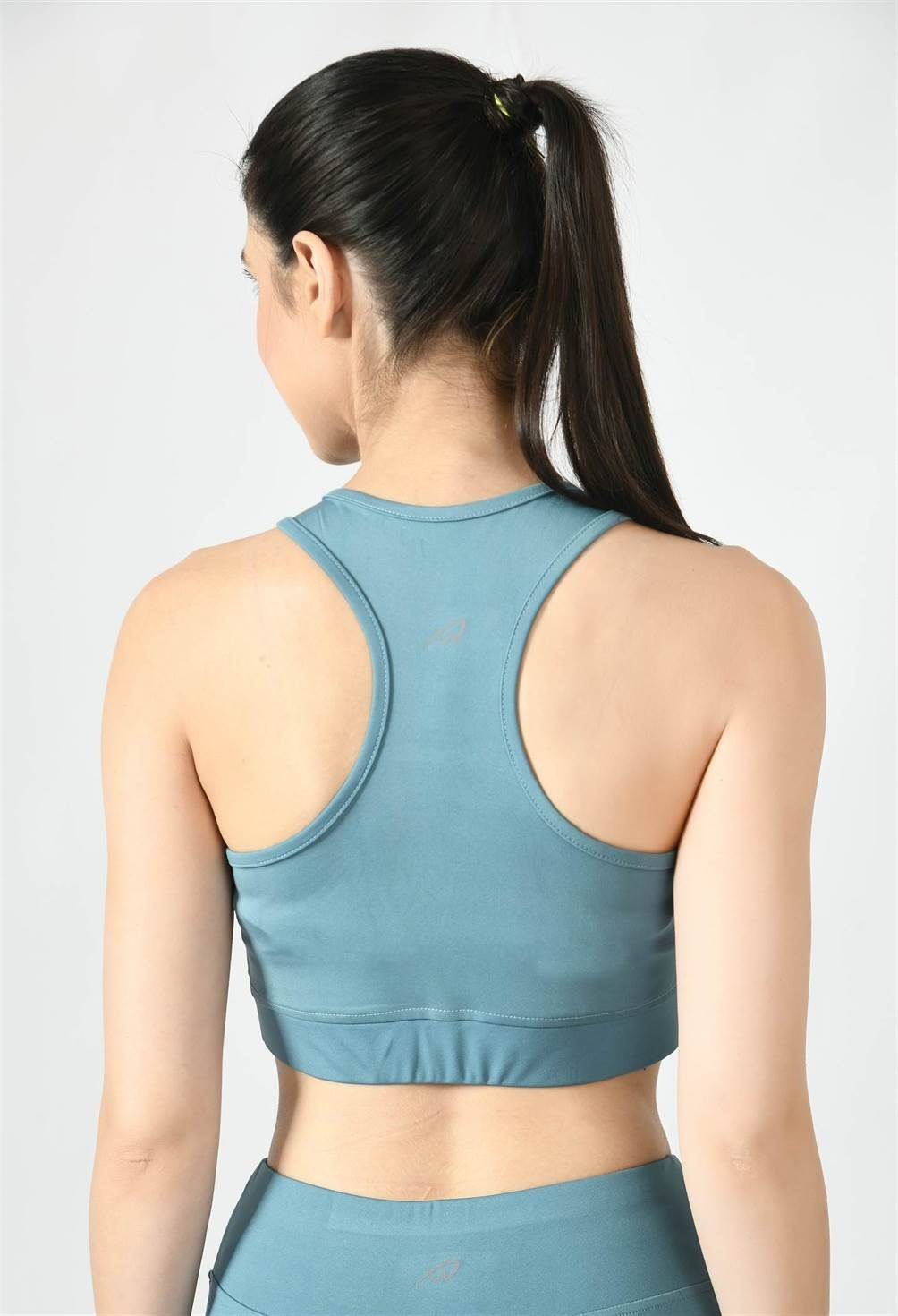 Model showcasing the comfortable fit of Waylene's light blue (Air Force Blue) sports bra - back view