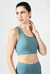 Model showcasing the comfortable fit of Waylene's light blue (Air Force Blue) sports bra - side view