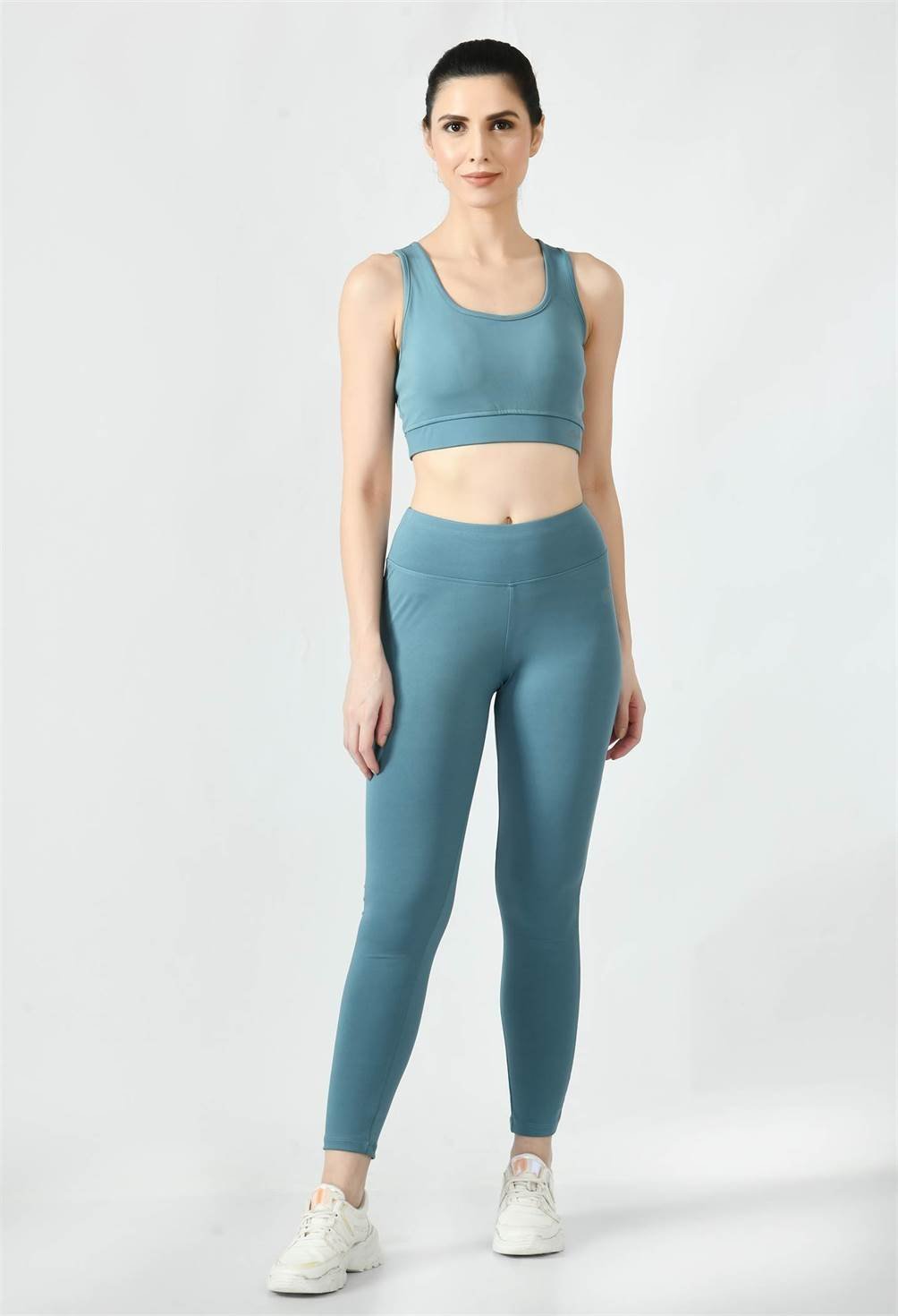 Model showcasing the comfortable fit of Waylene's light blue (Air Force Blue) sports bra with light blue sports leggings front view