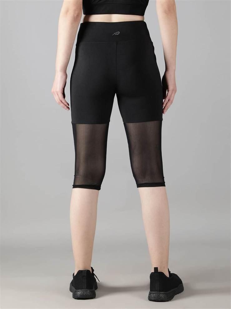 Women wearing gym & yoga wear Waylene black high-waisted capri leggings with rounded mesh panels – back view