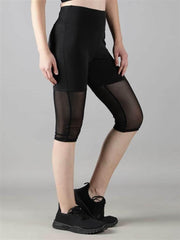 Women wearing gym & yoga wear Waylene black high-waisted capri leggings with rounded mesh panels – side view 2