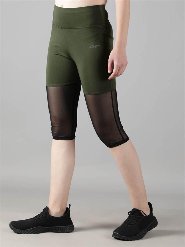 Woman practicing yoga in Waylene olive green high-waisted capri leggings with rounded mesh panels - side view