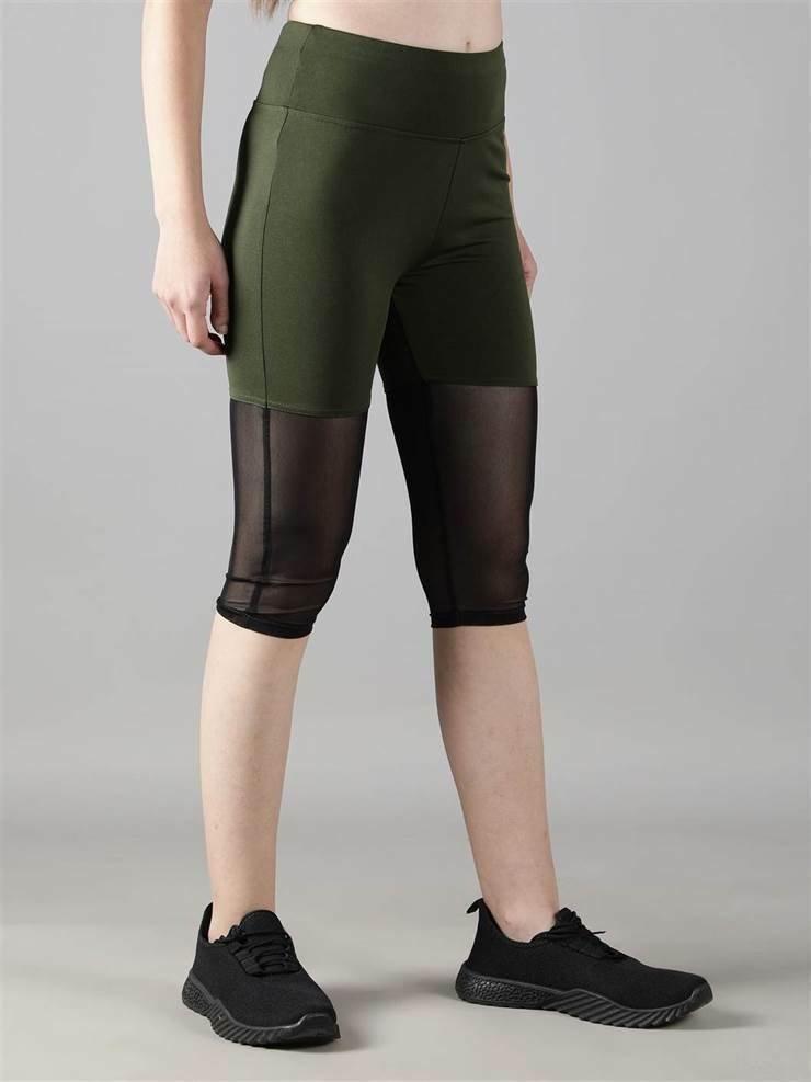 Woman practicing yoga in Waylene olive green high-waisted capri leggings with rounded mesh panels - side view 2