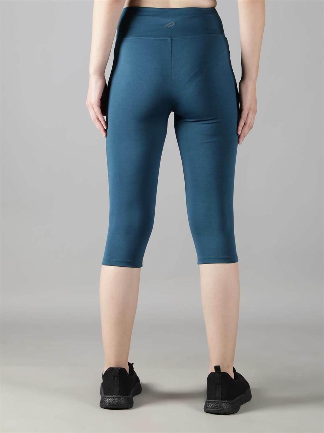 Woman practicing yoga in Waylene teal high-waisted plain sports capris back view