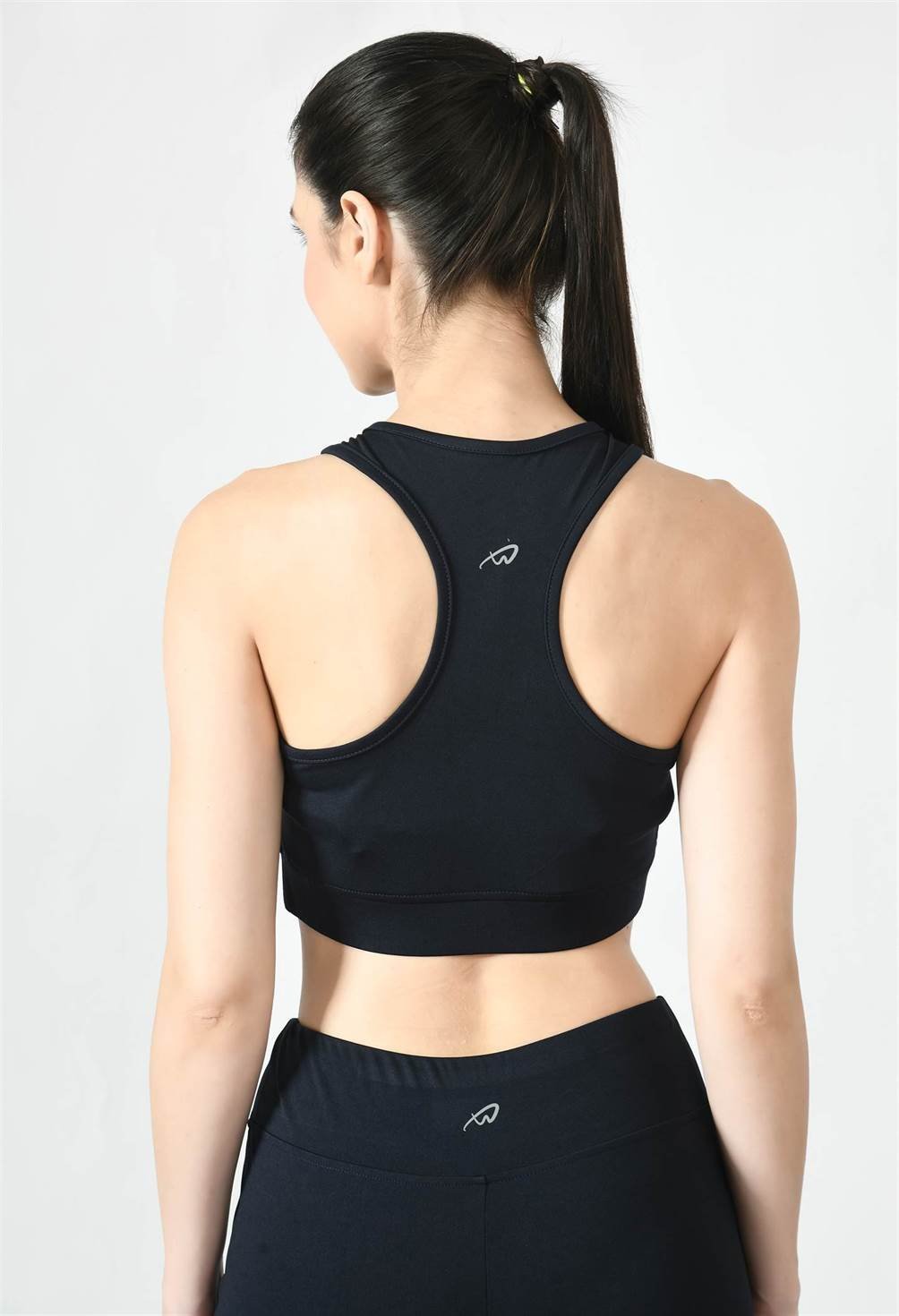 Close-up of Waylene navy blue sports bra showing racerback design and stretchable straps back view