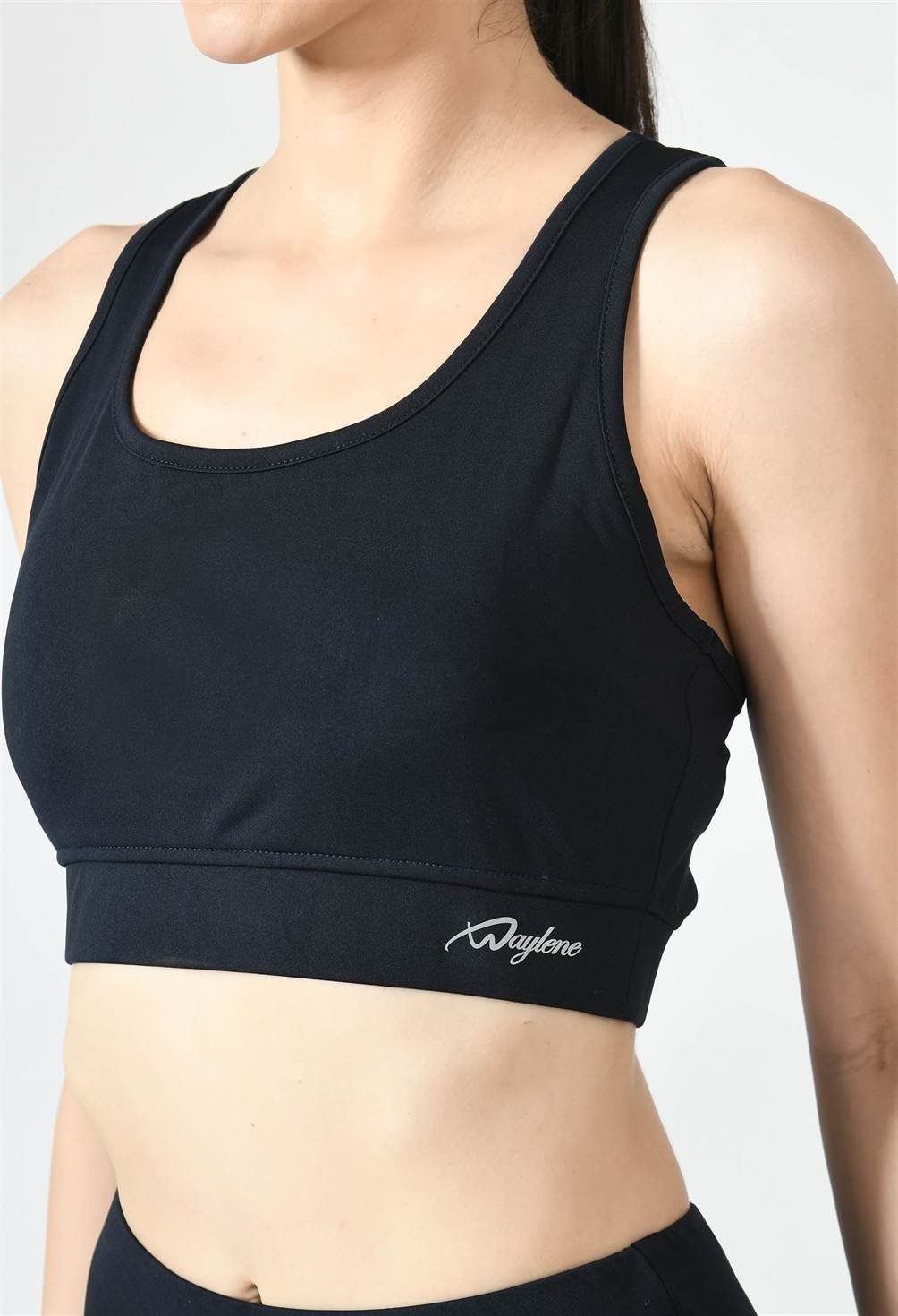 Close-up of Waylene navy blue sports bra showing racerback design and stretchable straps front view