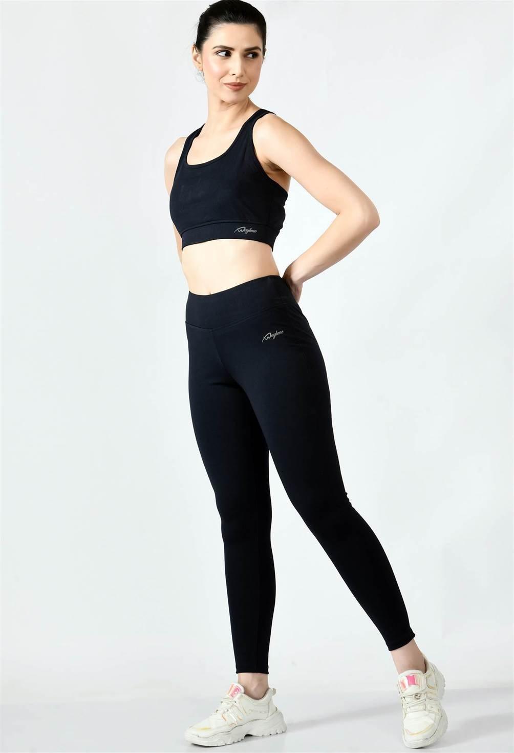 Model wearing Waylene black ankle-length yoga leggings during a yoga pose.